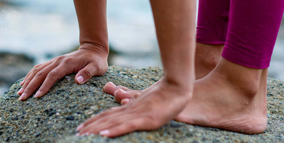 Woman doing yoga outdoors - Kinshe Yoga.